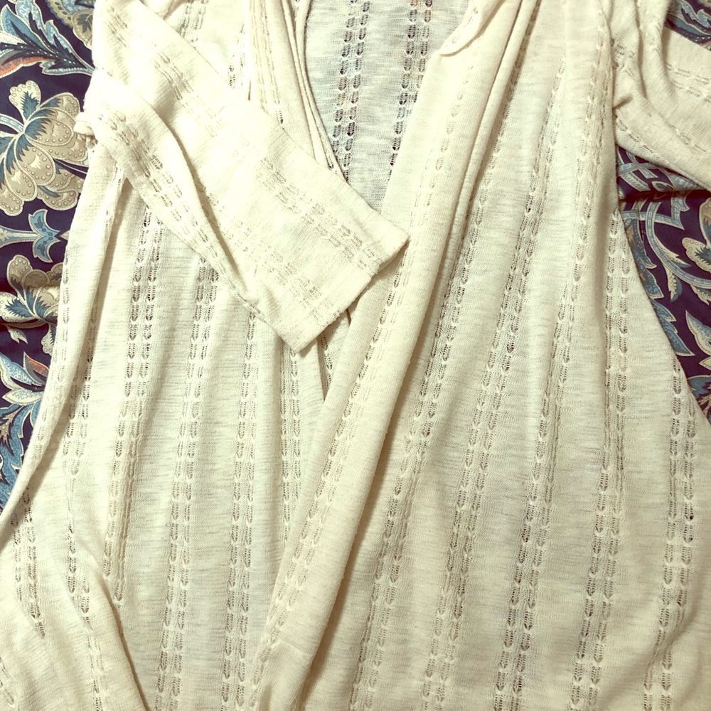 Short cream colored cardigan.